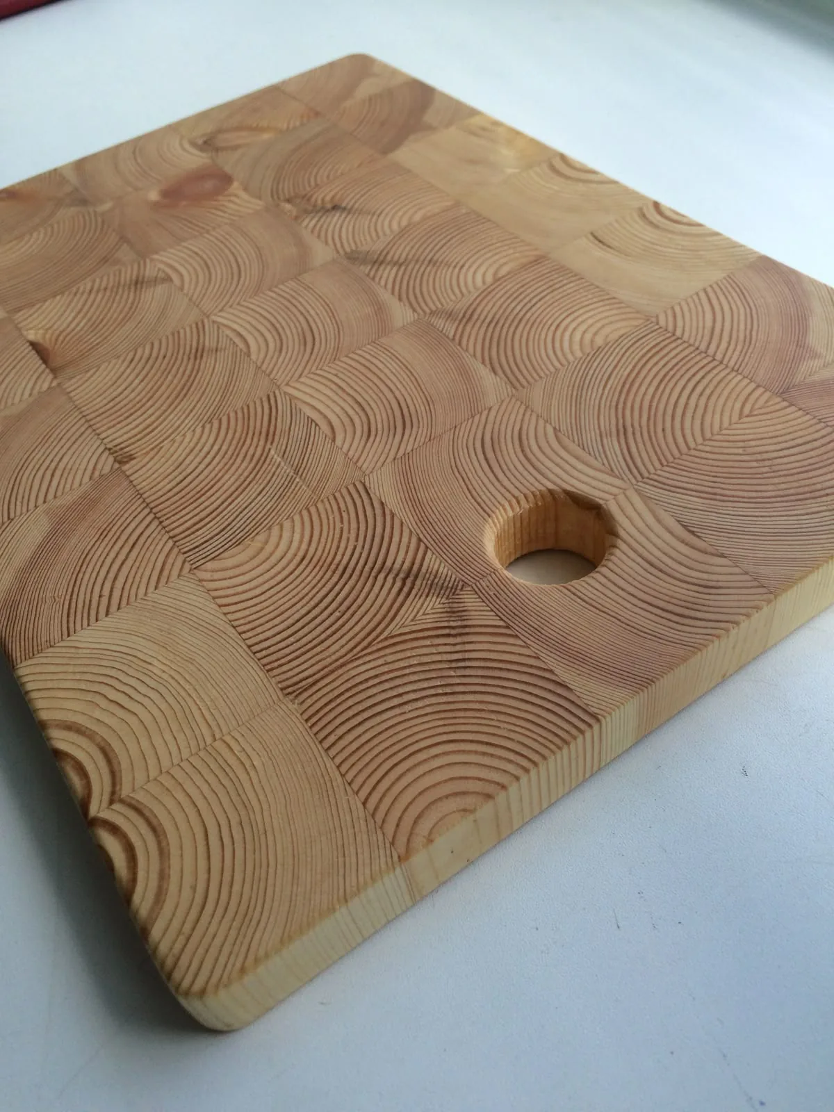 Pale end-grain board with a hang hole
